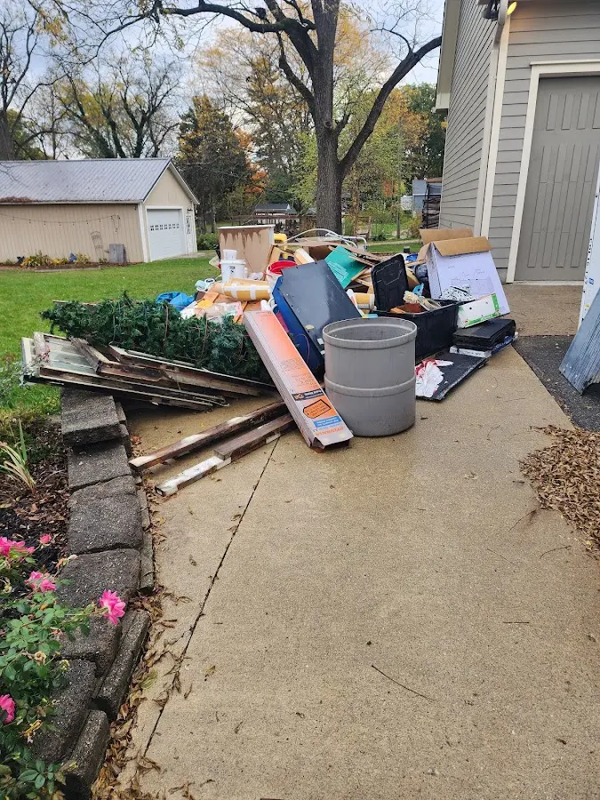 Dumpster being loaded with debris for 12 Yard Dumpster Rental in Dannemora